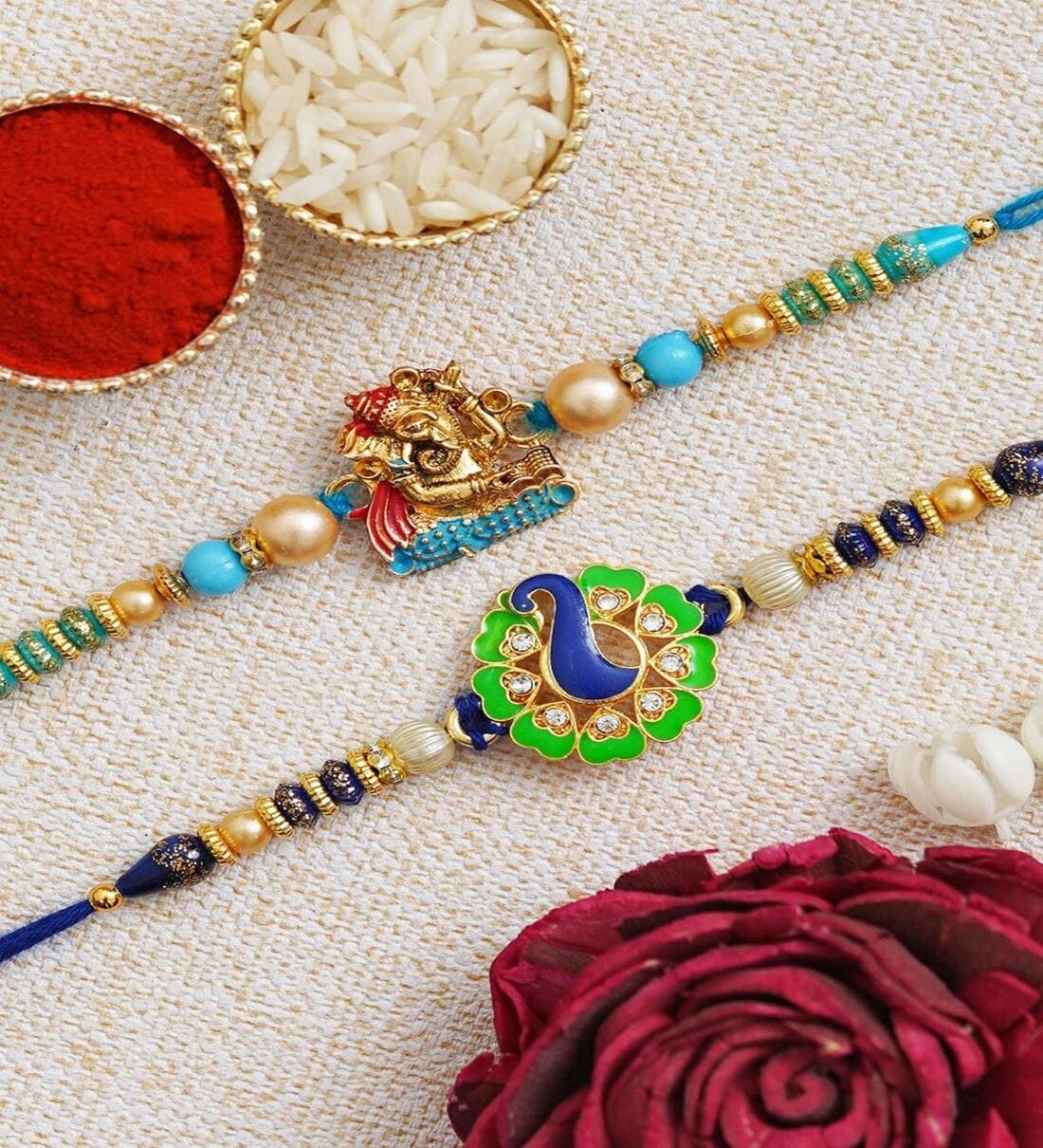 Ganesha & Peacock Design Rakhi Set (2 Rakhi, 1 Pack Roli Chawal)Share By Fashion Bizz